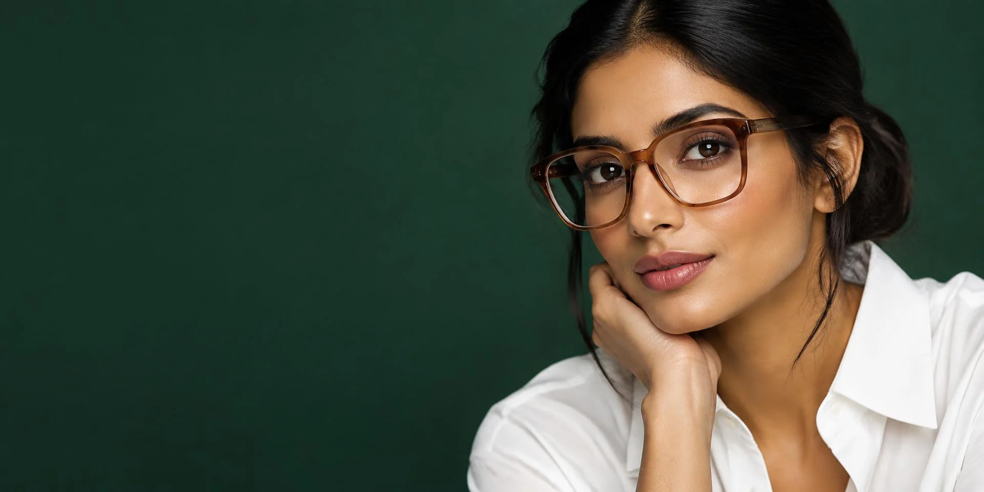 A woman wearing tortoiseshell optical eyeglasses